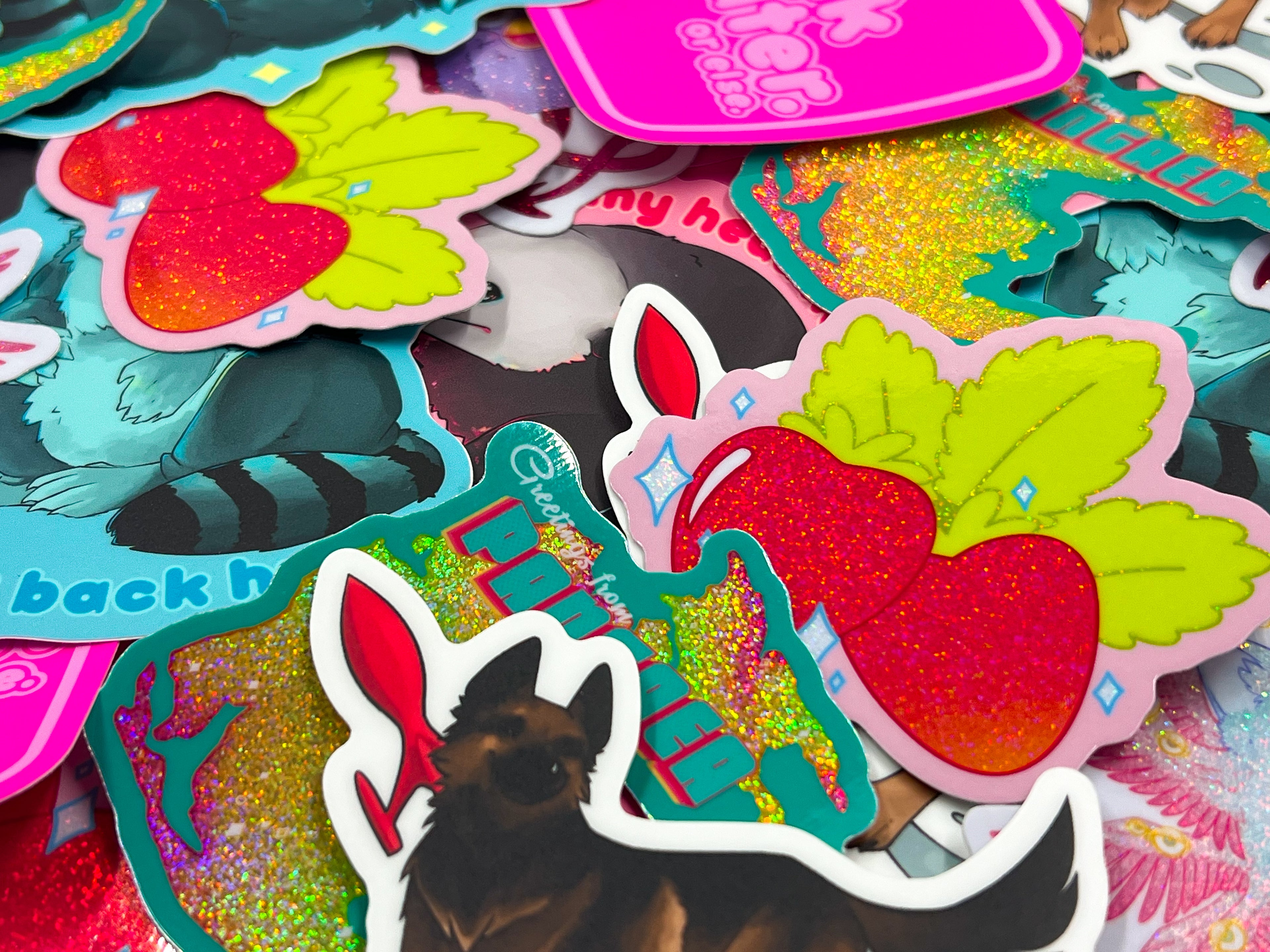 Image of various vinyl stickers, each one with a different special effect such as holographic or glitter.